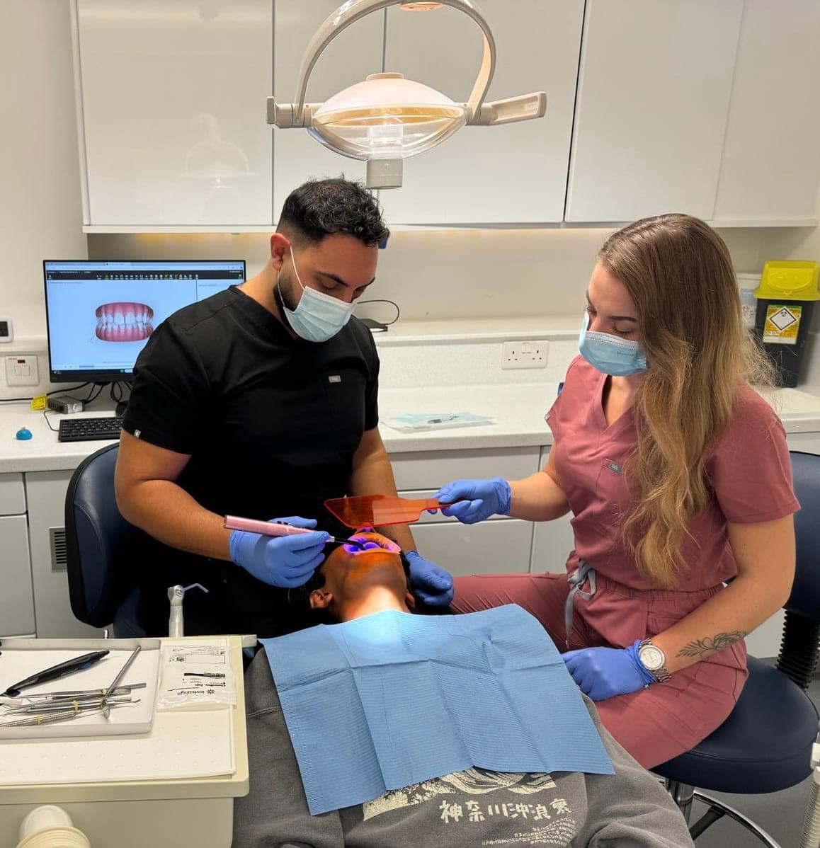 A Surrey Docks Dental dentist and dental nurse treating a patient in one of the surgeries